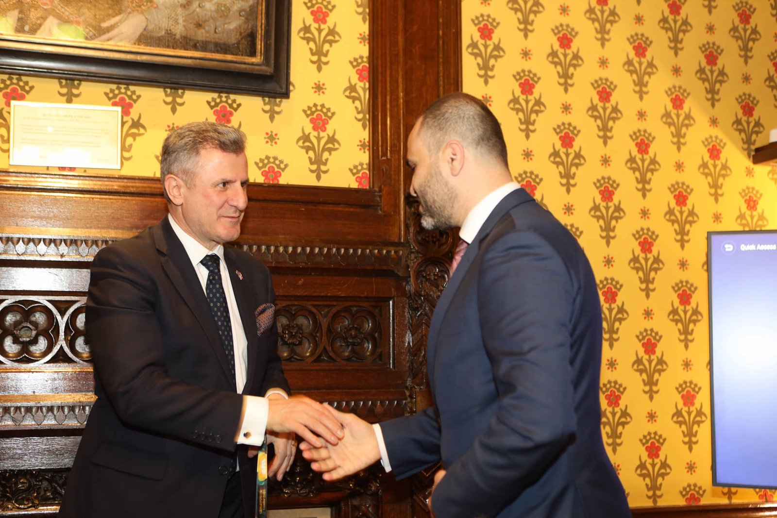 A handshake as an award is presented at the London ceremony