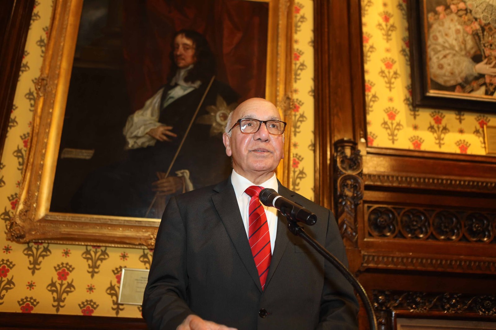 A speaker addresses the room from the lectern at the London ceremony