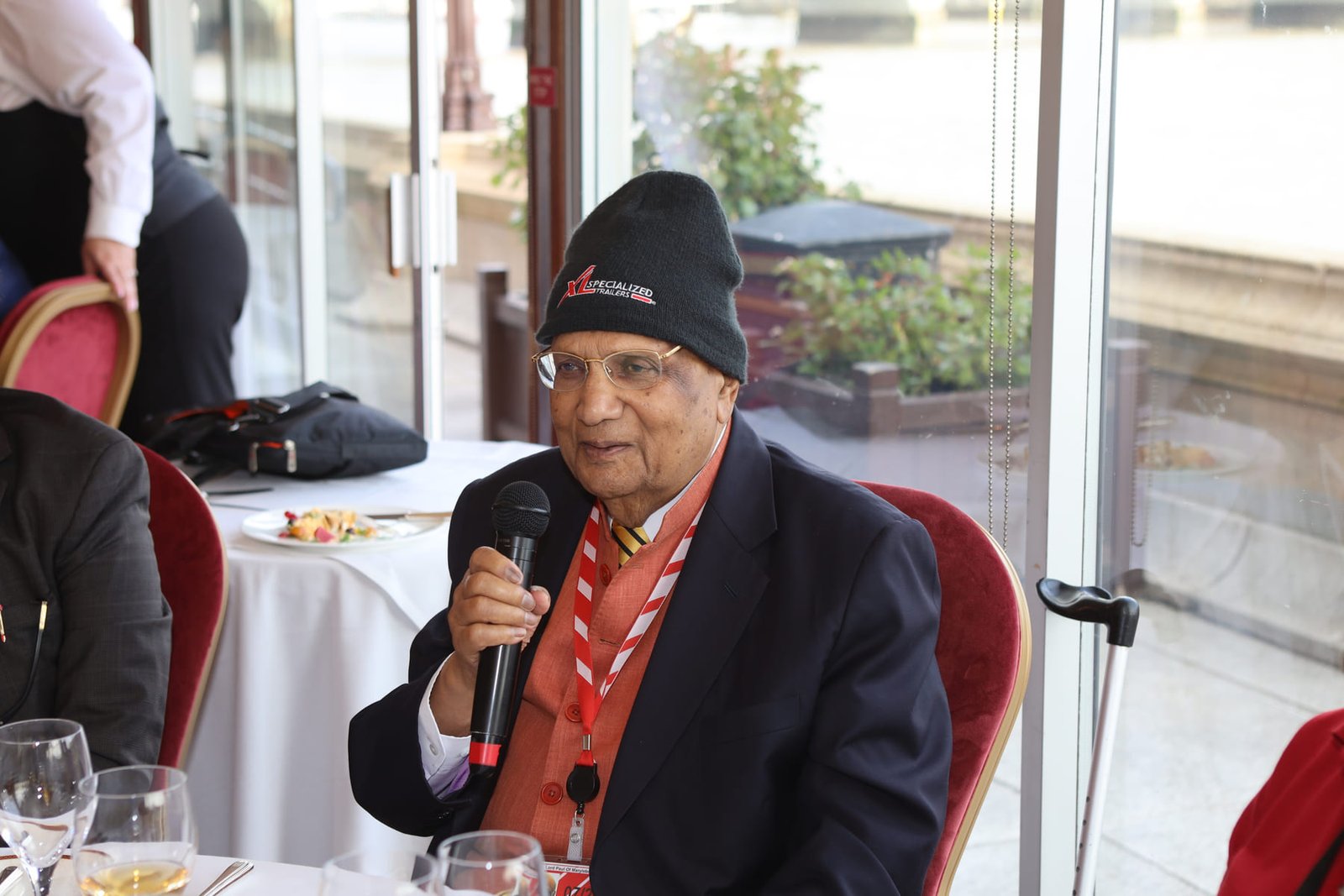 A delegate speaks into the microphone during the round-table lunch overlooking the Thames