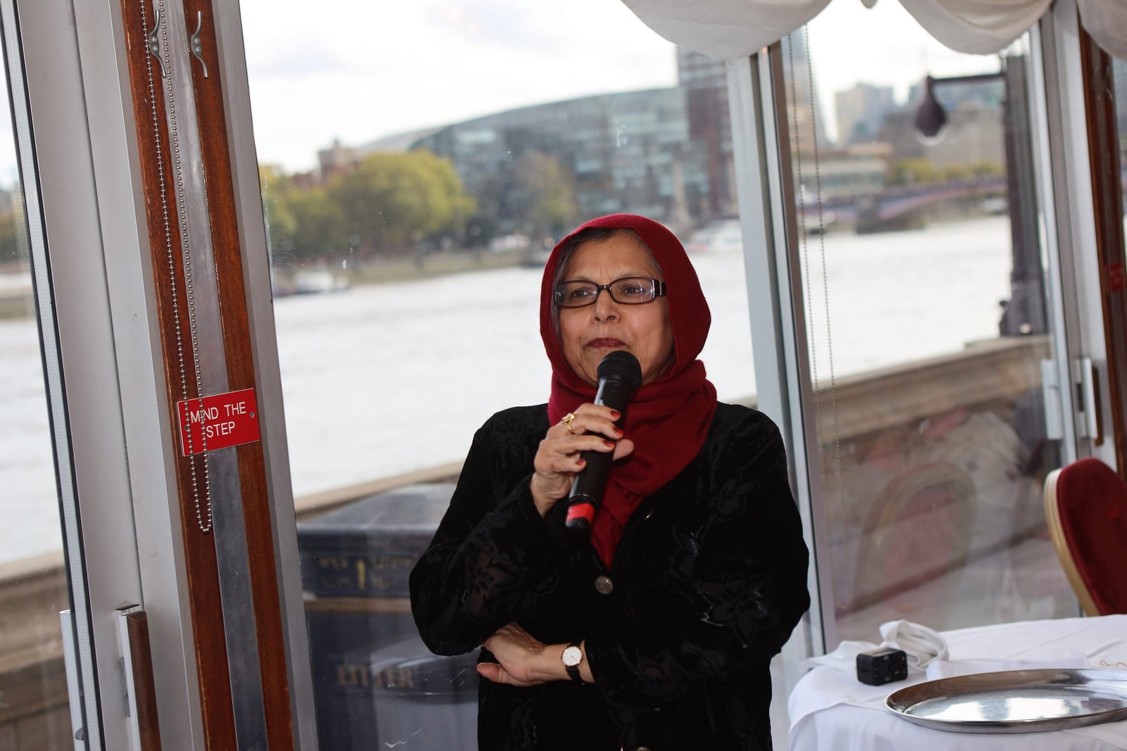 A delegate makes a point during the round-table lunch, the Thames behind