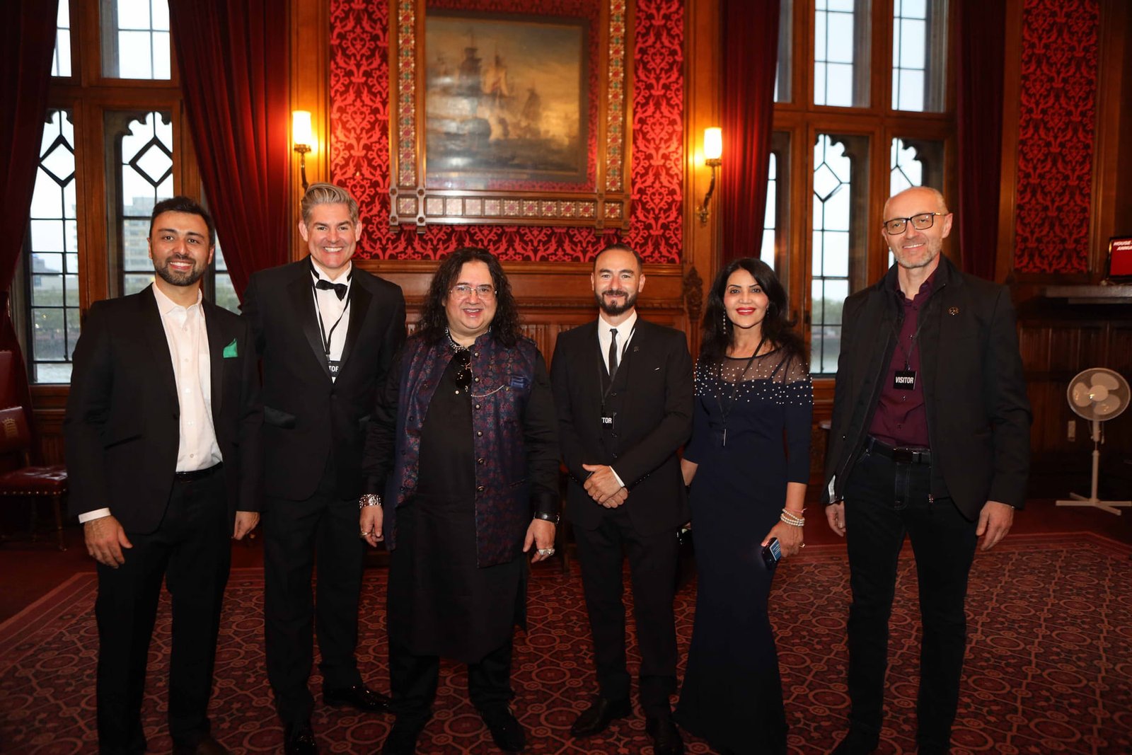 Six guests in evening dress at the reception in the Cholmondeley Room