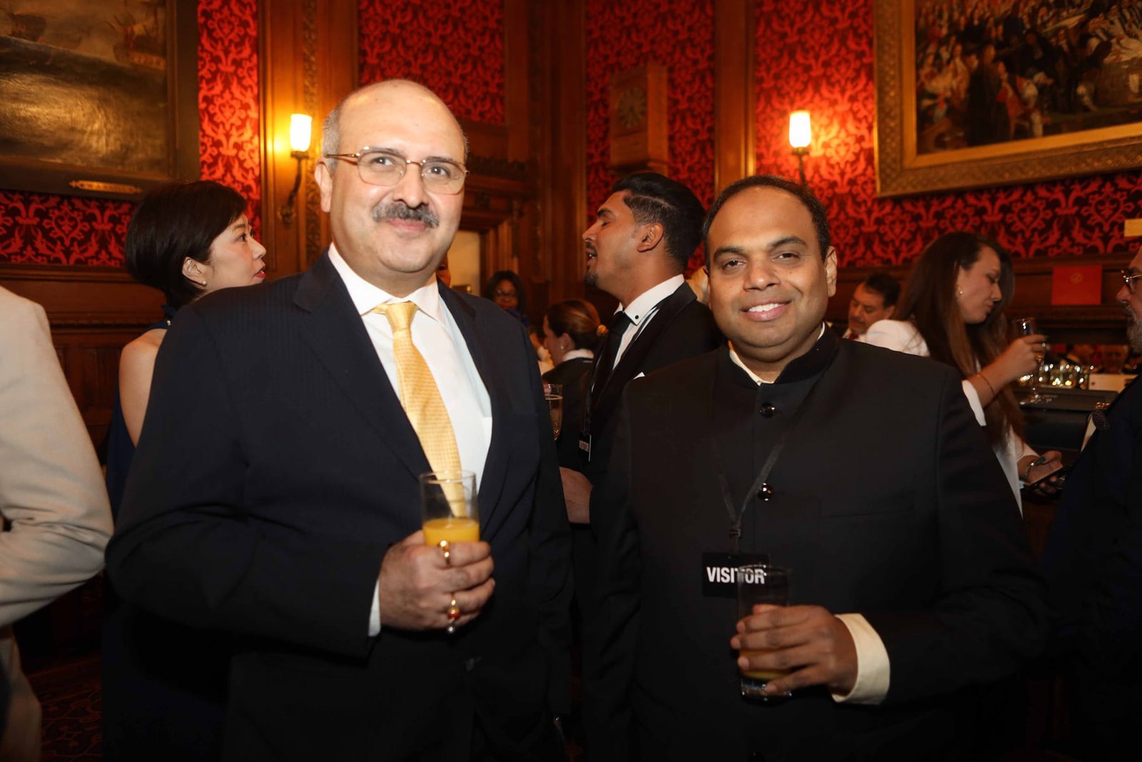 Two guests with drinks at the evening reception
